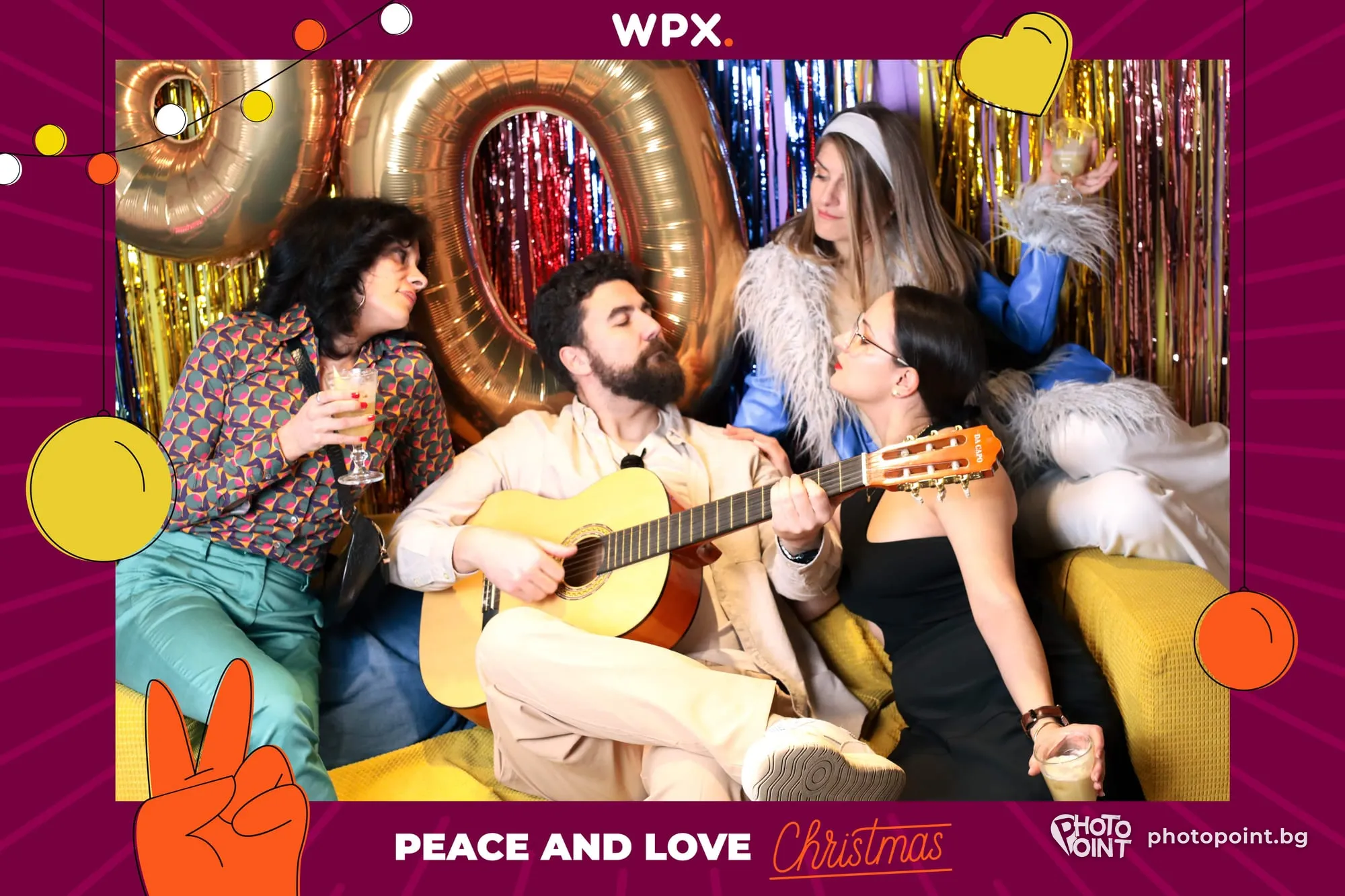 A colleague playing the guitar among colleagues in hippie style