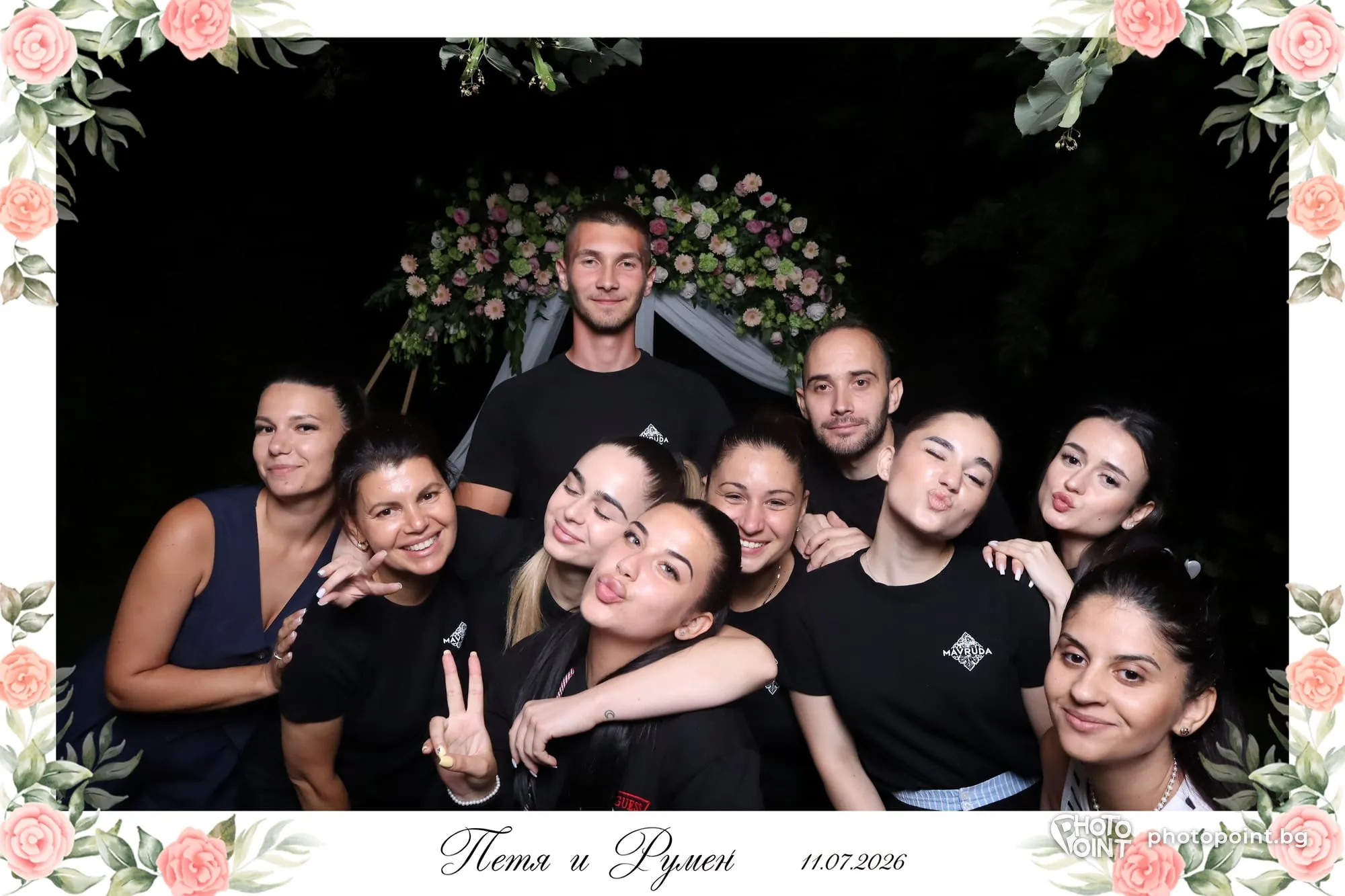 The newlyweds' friends posing in the evening in a floral photo frame