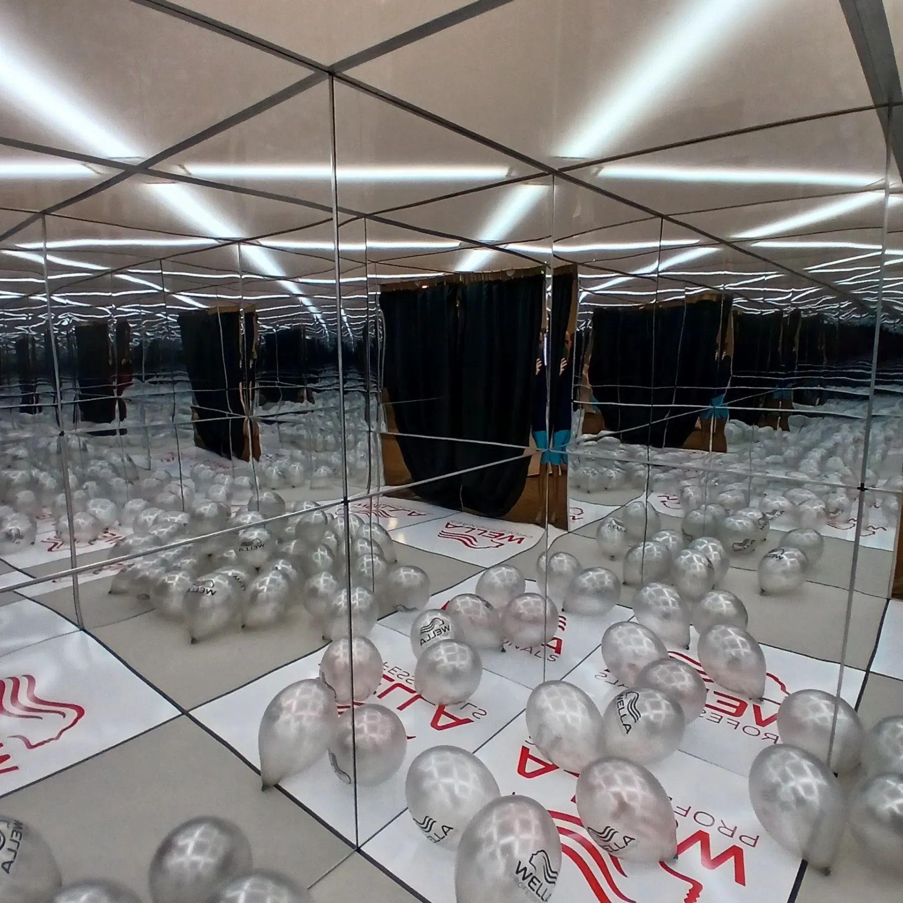 The InfinityPoint LED mirror room filled with balloons at a branded event