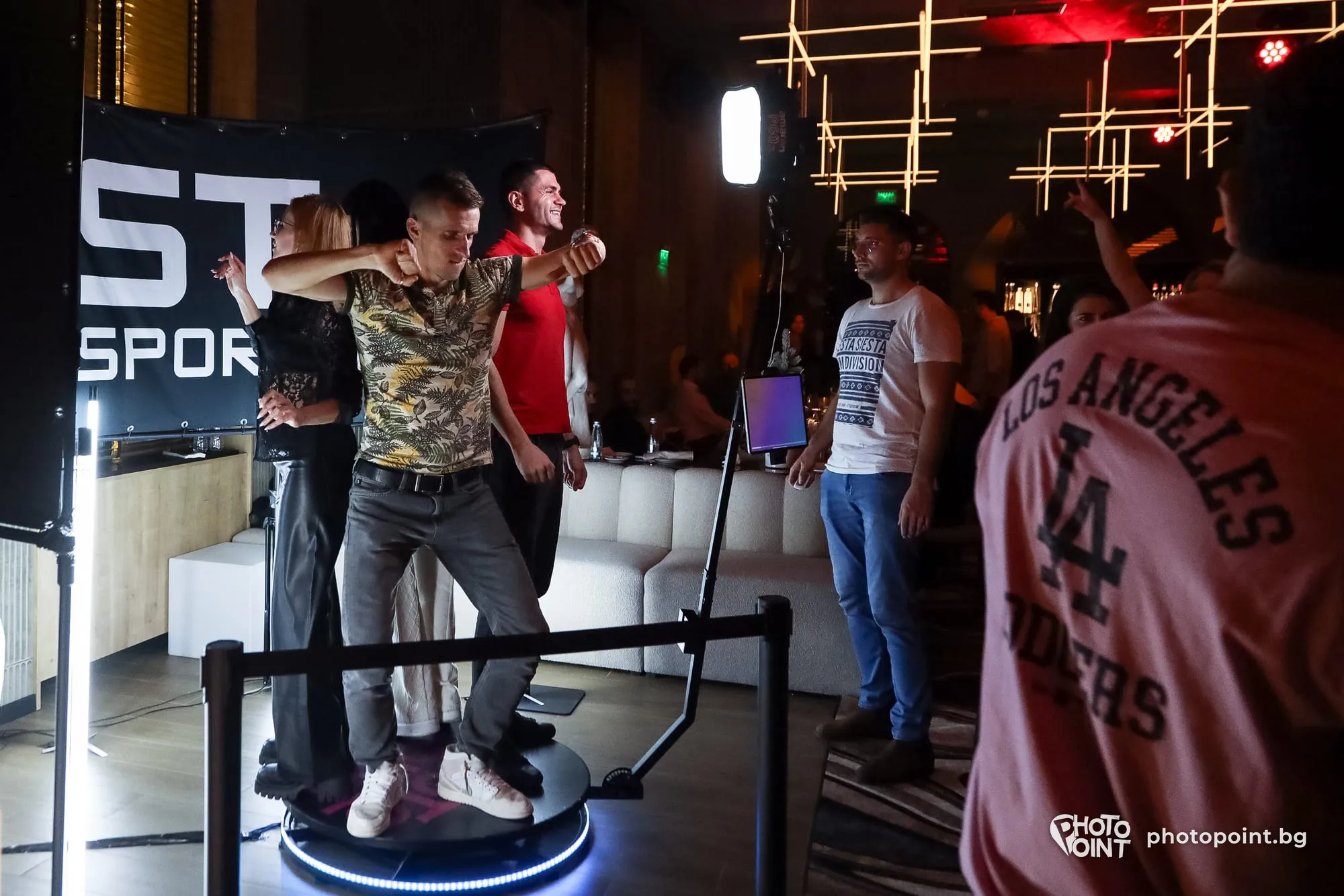Guests dancing on the 360° video booth in a sports bar